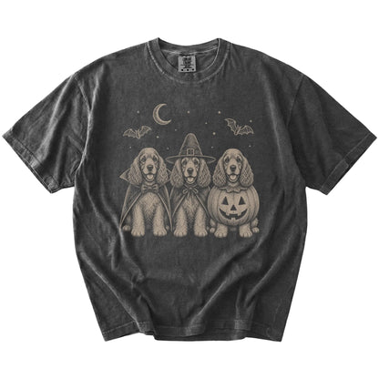 Three Cocker Spaniel dogs dressed for Halloween beneath bats and a crescent moon on a Pepper Comfort Colors® T-shirt