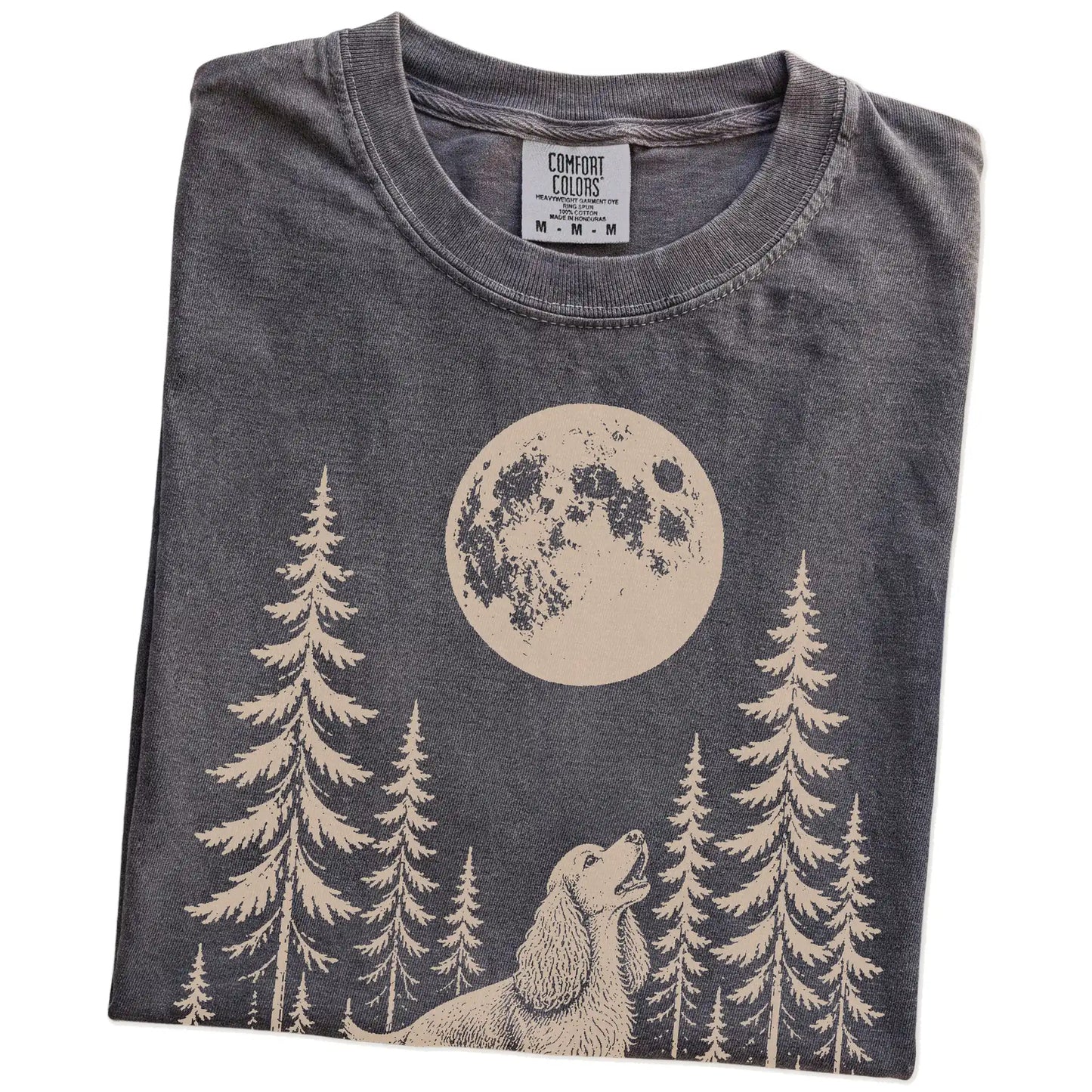Folded Pepper Comfort Colors® T-shirt showing a Cocker Spaniel howling beneath the moon and pine trees