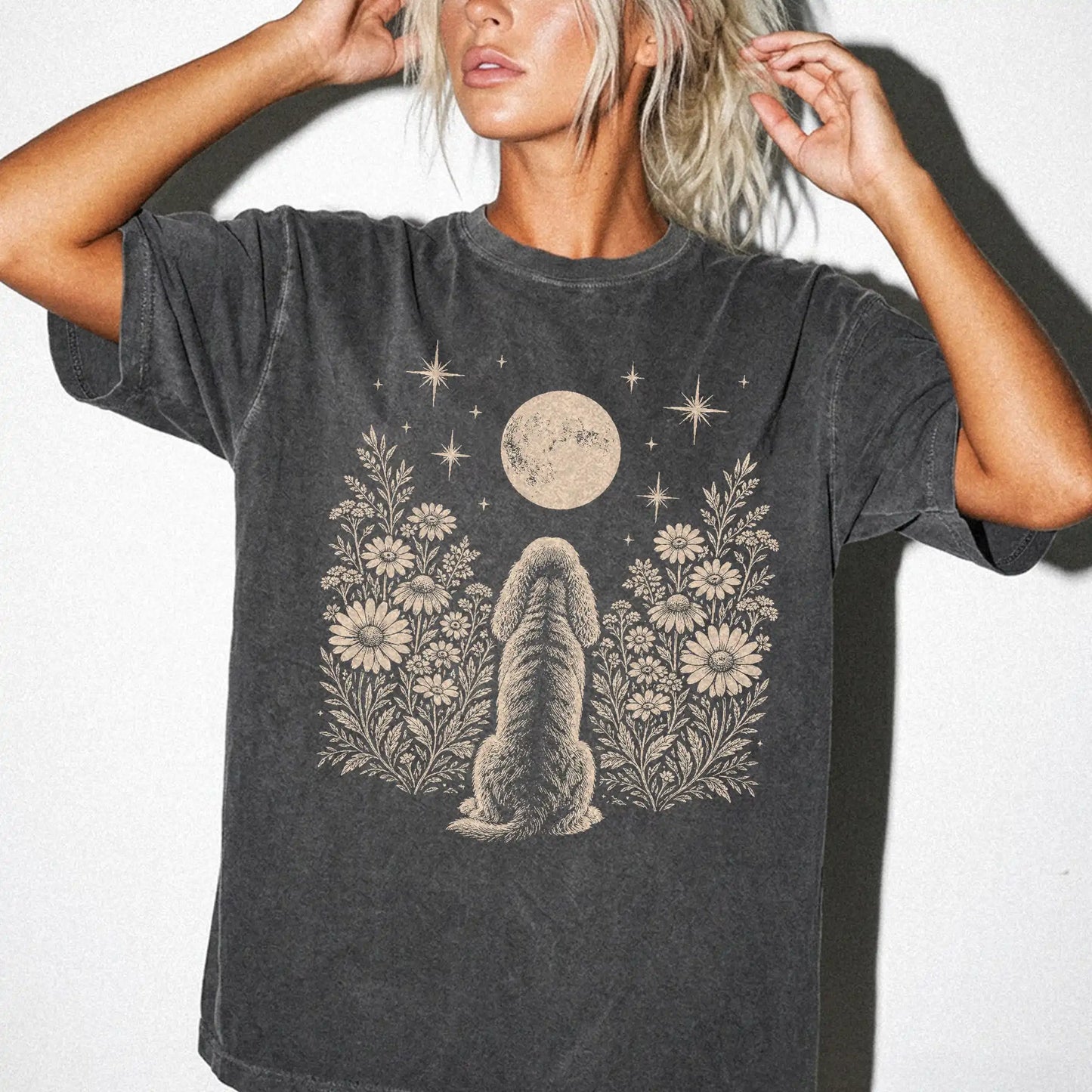 Model wearing a Pepper Comfort Colors® T-shirt featuring Cocker Spaniel beneath a wildflower moon