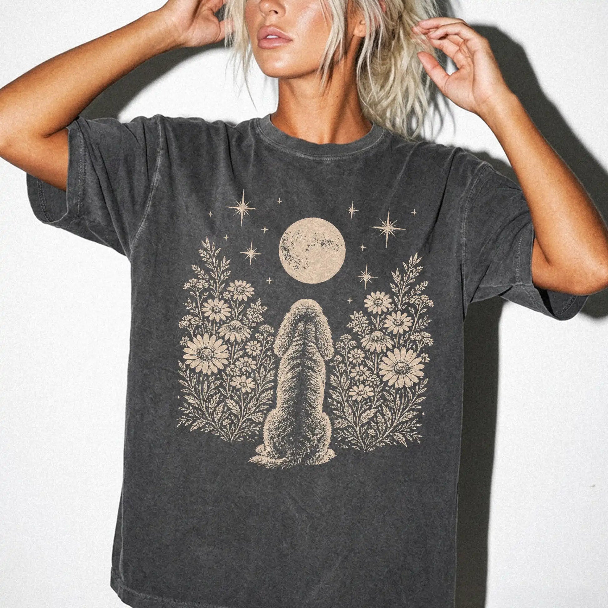 Model wearing a Pepper Comfort Colors® T-shirt featuring Cocker Spaniel beneath a wildflower moon