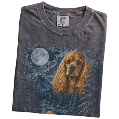 Folded pepper T-shirt with Cocker Spaniel Winter Moon artwork.