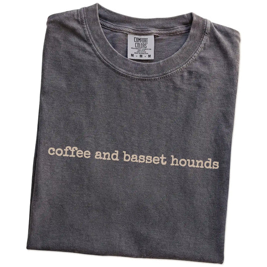 Folded Pepper Comfort Colors® T-shirt showing “coffee and basset hounds” retro text