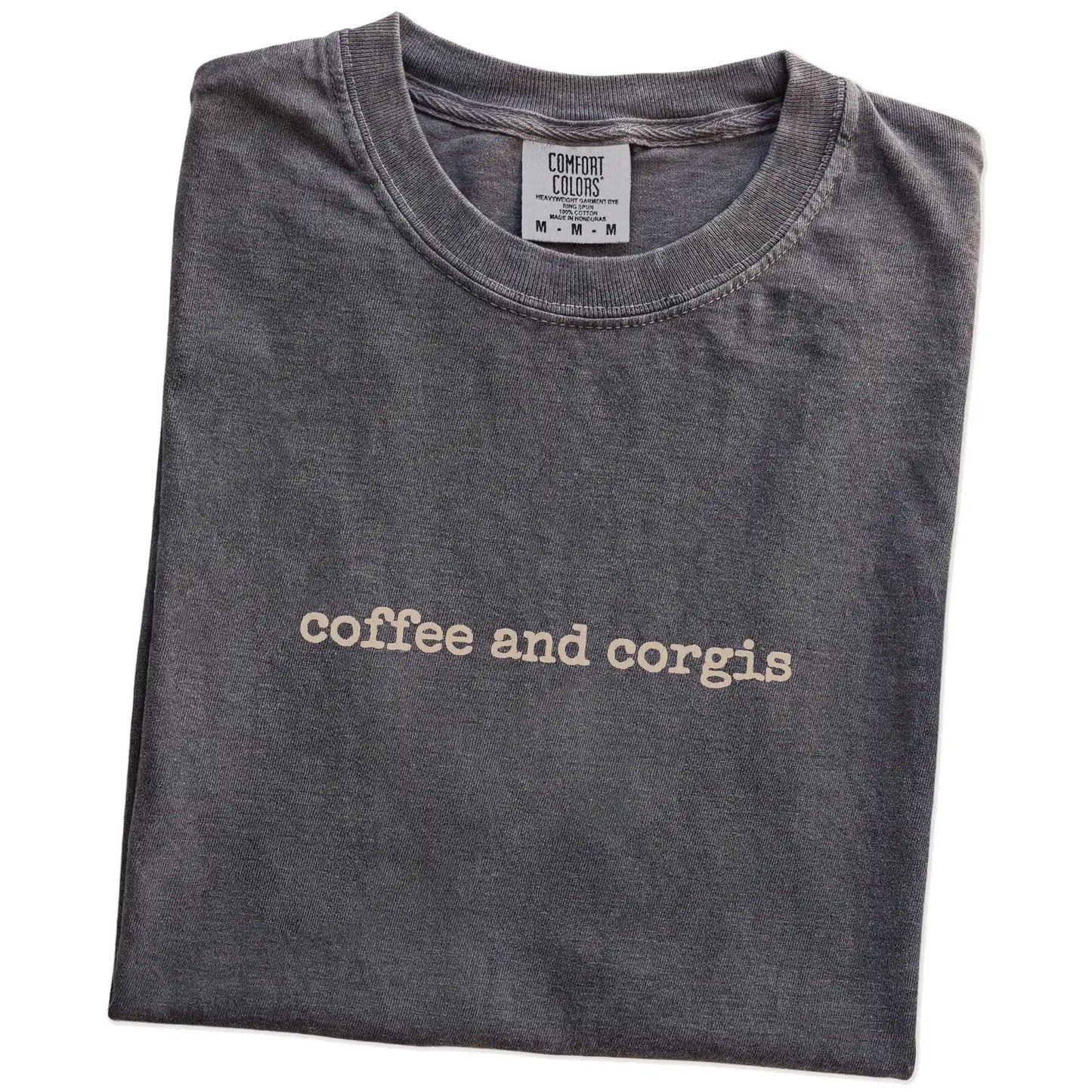 Folded Pepper Comfort Colors® T-shirt showing “coffee and corgis” retro text