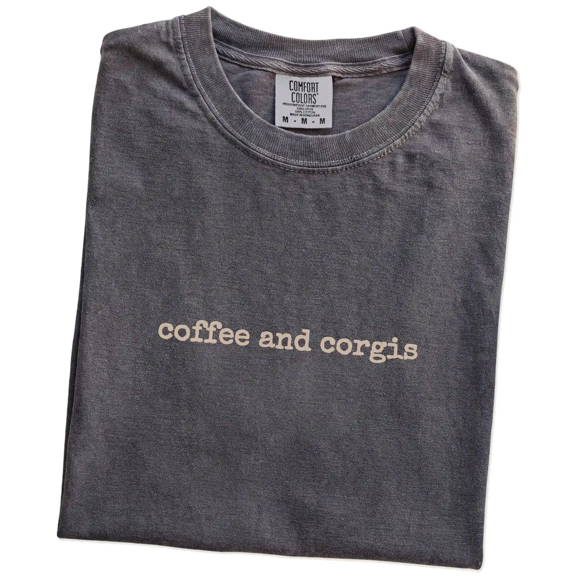 Folded Pepper Comfort Colors® T-shirt showing “coffee and corgis” retro text