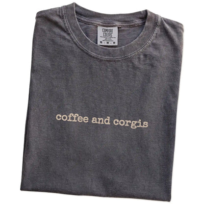 Folded Pepper Comfort Colors® T-shirt showing “coffee and corgis” retro text
