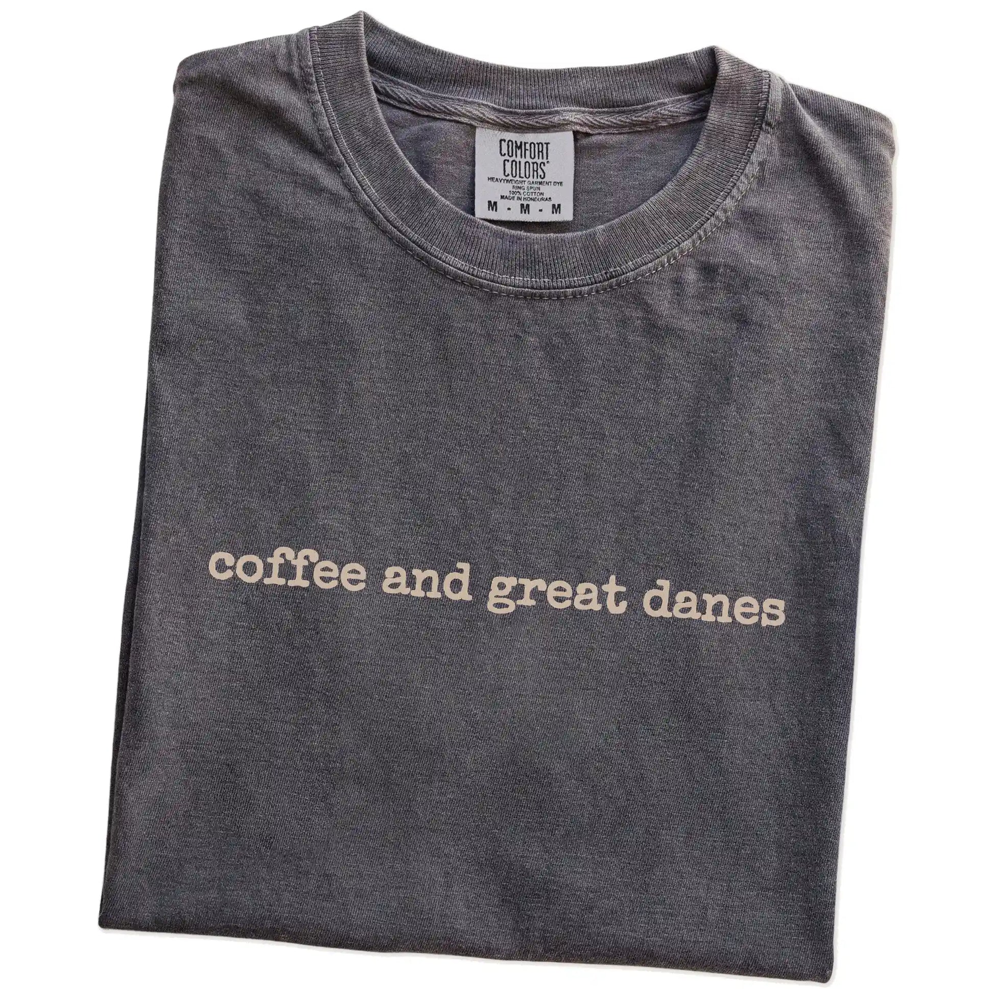 Folded Pepper Comfort Colors® T-shirt showing “coffee and great danes” retro text