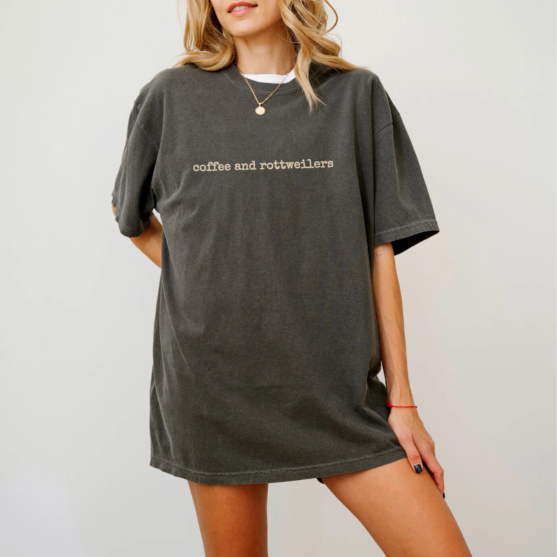Model wearing a Pepper Comfort Colors® T-shirt with “coffee and rottweilers” retro text