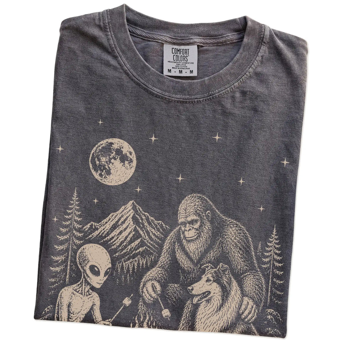 Folded Pepper Comfort Colors® T-shirt showing Collie camping with Bigfoot and an alien