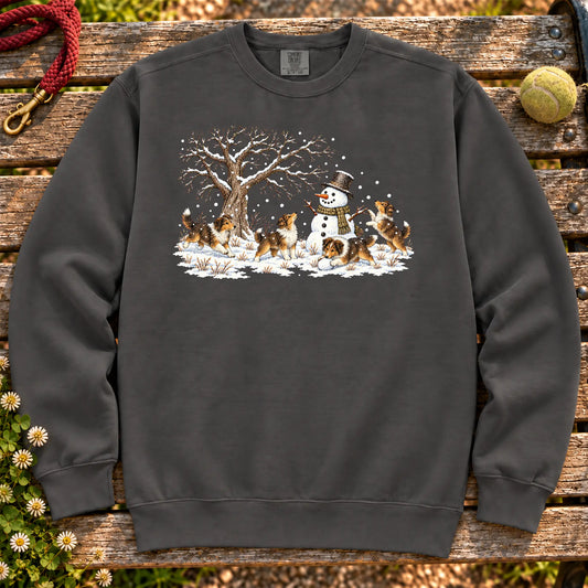 Collie puppies playing in snow with a snowman on a Pepper sweatshirt
