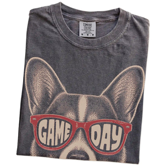 Folded Pepper Comfort Colors® T-shirt showing corgi wearing red game day sunglasses