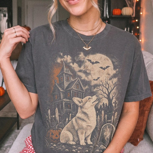 Model wearing a Pepper Comfort Colors® T-shirt showing Corgi in a vintage haunted-house scene