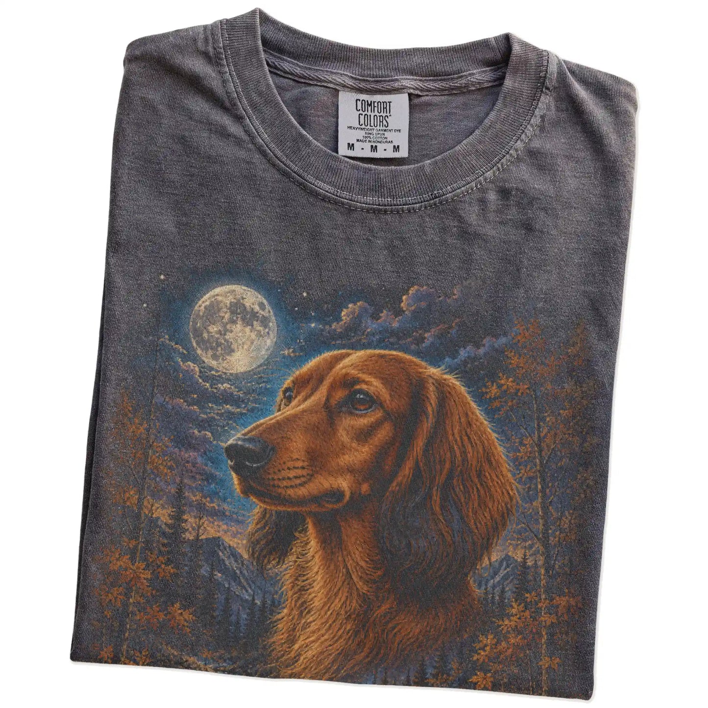 Folded Pepper Comfort Colors® t-shirt showing Dachshund in a fall forest graphic