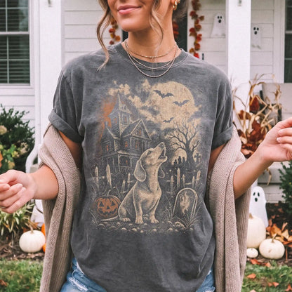Model wearing a Pepper Comfort Colors® T-shirt showing Dachshund in a vintage haunted-house scene