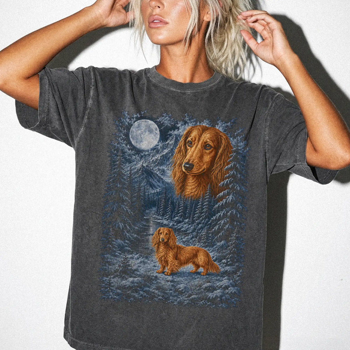 Model wearing a pepper T-shirt with Dachshund Winter Moon artwork.