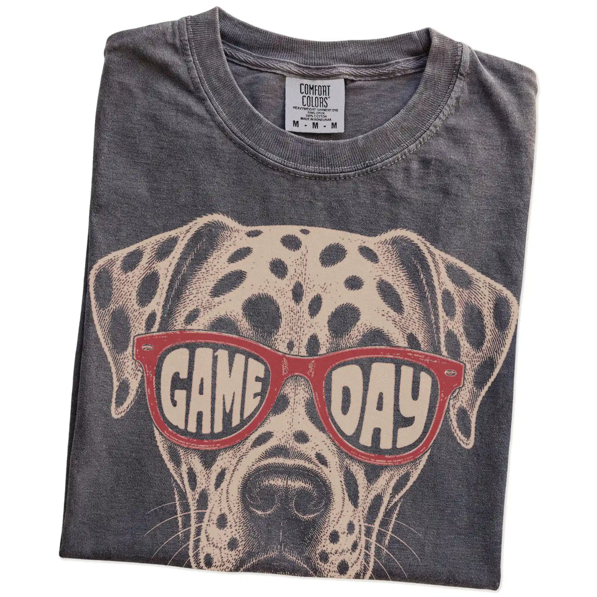 Folded Pepper Comfort Colors® T-shirt showing dalmatian wearing red game day sunglasses