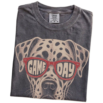 Folded Pepper Comfort Colors® T-shirt showing dalmatian wearing red game day sunglasses
