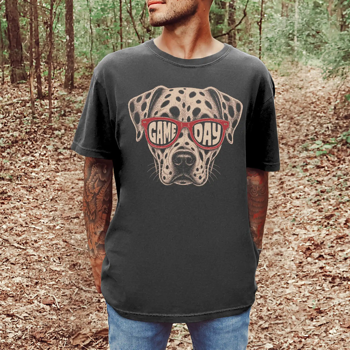 Model wearing a Pepper Comfort Colors® T-shirt with dalmatian wearing red game day sunglasses