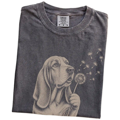Folded Pepper Comfort Colors® T-shirt showing Basset Hound portrait with drifting dandelion seeds