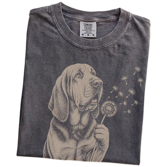 Folded Pepper Comfort Colors® T-shirt showing Bloodhound portrait with drifting dandelion seeds