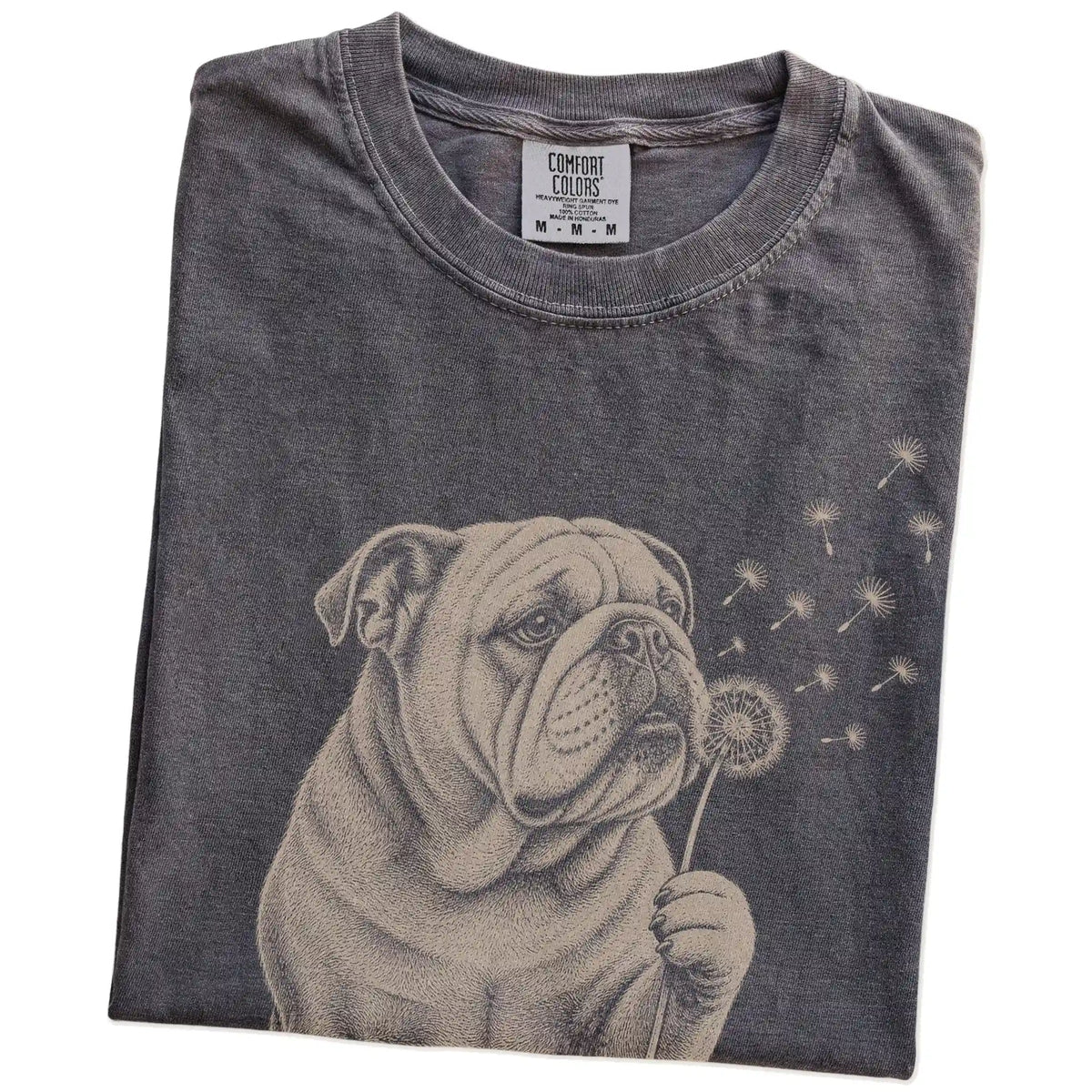 Folded Pepper Comfort Colors® T-shirt showing Bulldog portrait with drifting dandelion seeds