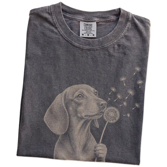 Folded Pepper Comfort Colors® T-shirt showing Dachshund portrait with drifting dandelion seeds