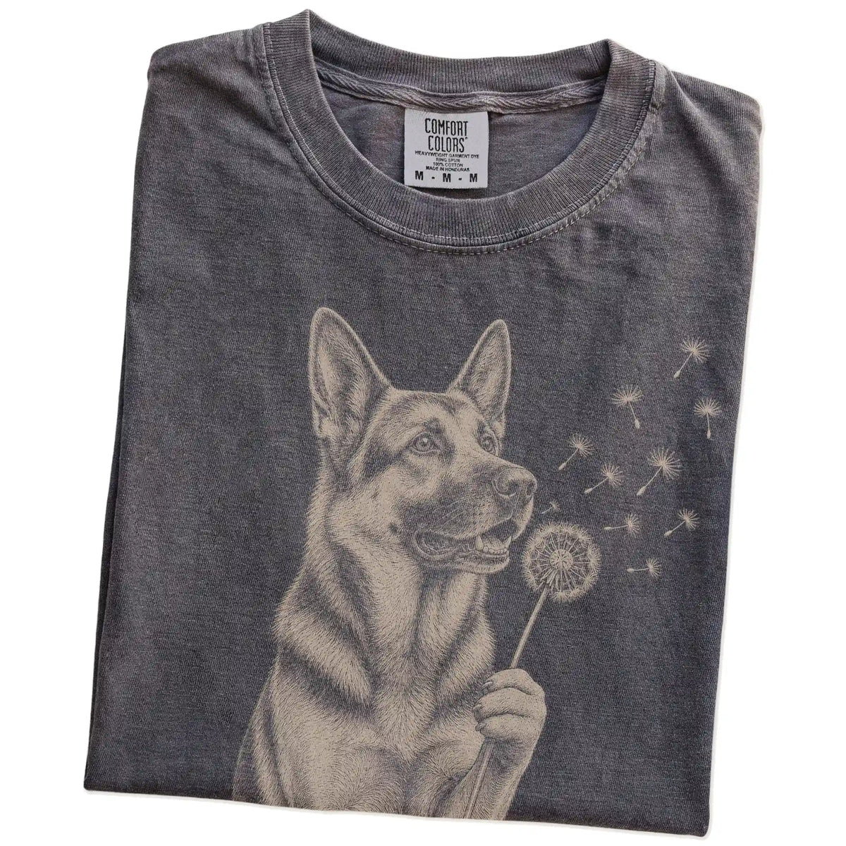Folded Pepper Comfort Colors® T-shirt showing German Shepherd portrait with drifting dandelion seeds