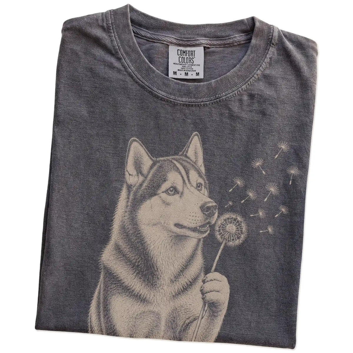Folded Pepper Comfort Colors® T-shirt showing Husky portrait with drifting dandelion seeds