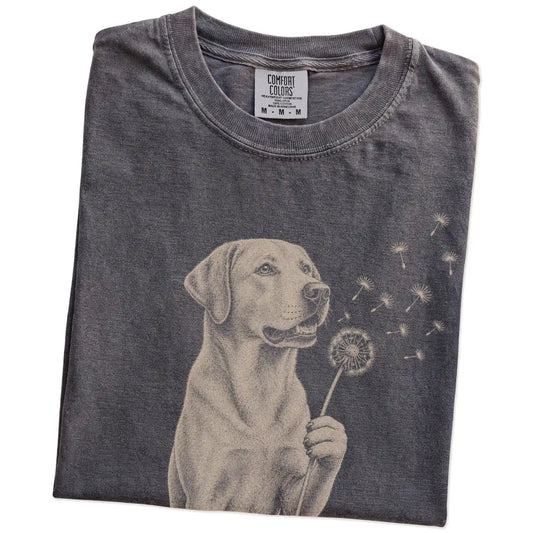 Folded Pepper Comfort Colors® T-shirt showing Labrador Retriever portrait with drifting dandelion seeds