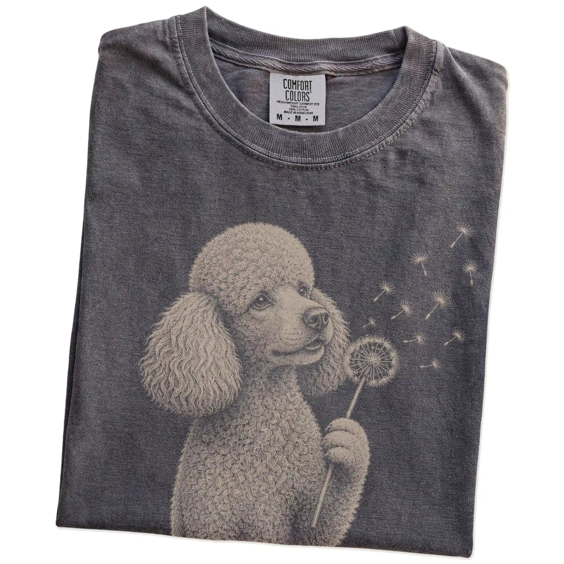 Folded Pepper Comfort Colors® T-shirt showing Poodle portrait with drifting dandelion seeds