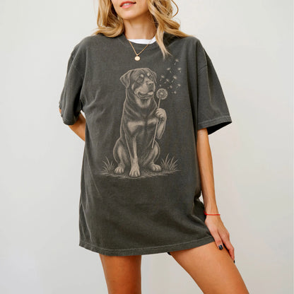 Model wearing a Pepper Comfort Colors® T-shirt showing Rottweiler portrait with drifting dandelion seeds