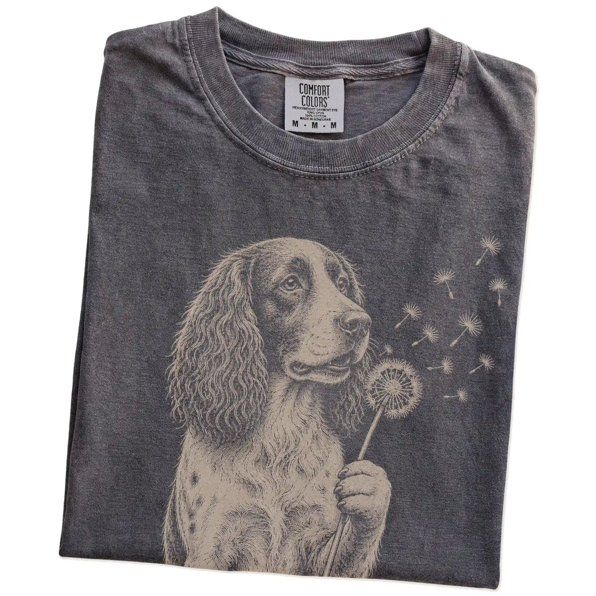 Folded Pepper Comfort Colors® T-shirt showing Springer Spaniel portrait with drifting dandelion seeds