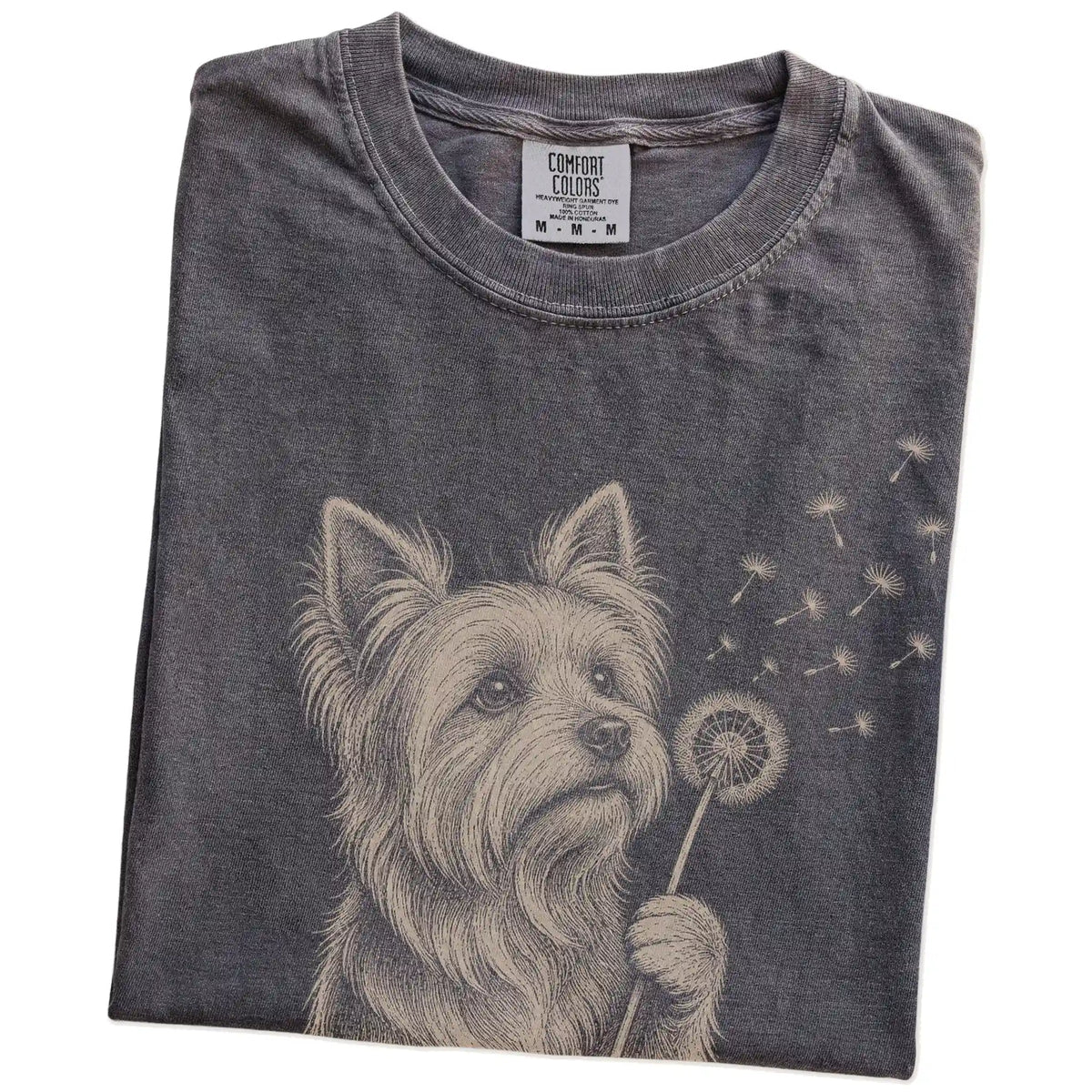Folded Pepper Comfort Colors® T-shirt showing Yorkie portrait with drifting dandelion seeds