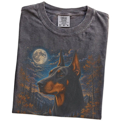 Folded pepper T-shirt with Doberman Autumn Moon artwork.