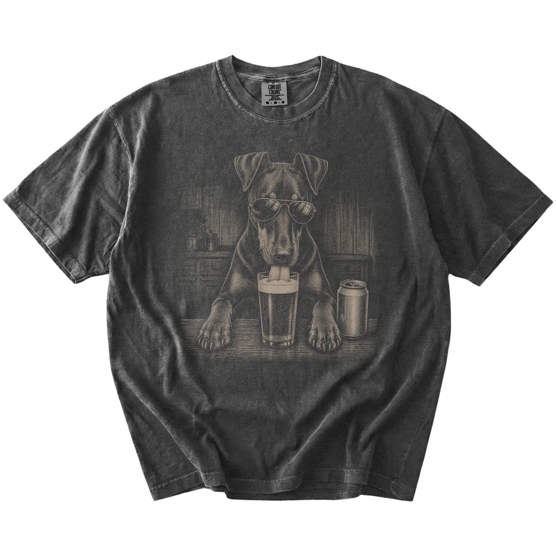 Doberman sneaking a drink from a foamy pint at home on a Pepper Comfort Colors® t-shirt