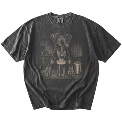 Doberman sneaking a drink from a foamy pint at home on a Pepper Comfort Colors® t-shirt