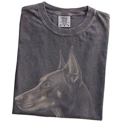 Folded Pepper Comfort Colors® T-shirt showing a detailed photographic portrait of a Doberman