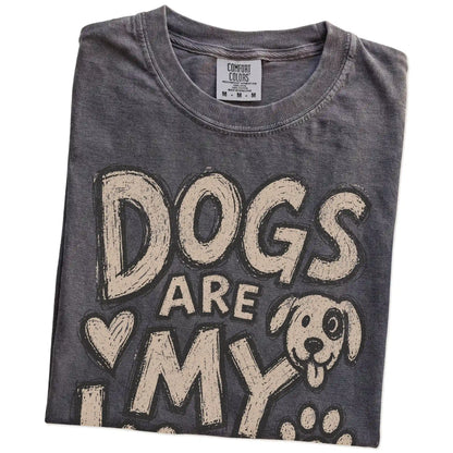 Folded Pepper Comfort Colors® T-shirt showing dogs are my kind of people lettering