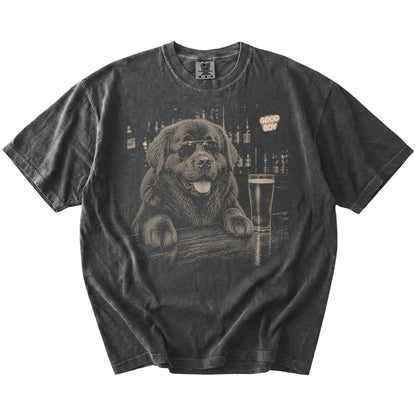 Pepper Newfie at a bar beside a pint, laid flat
