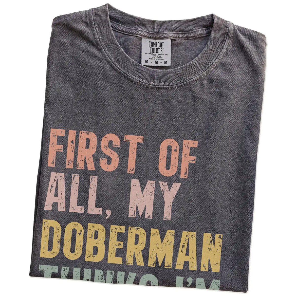 Folded Pepper Comfort Colors® T-shirt showing “My Doberman thinks I’m delightful” text