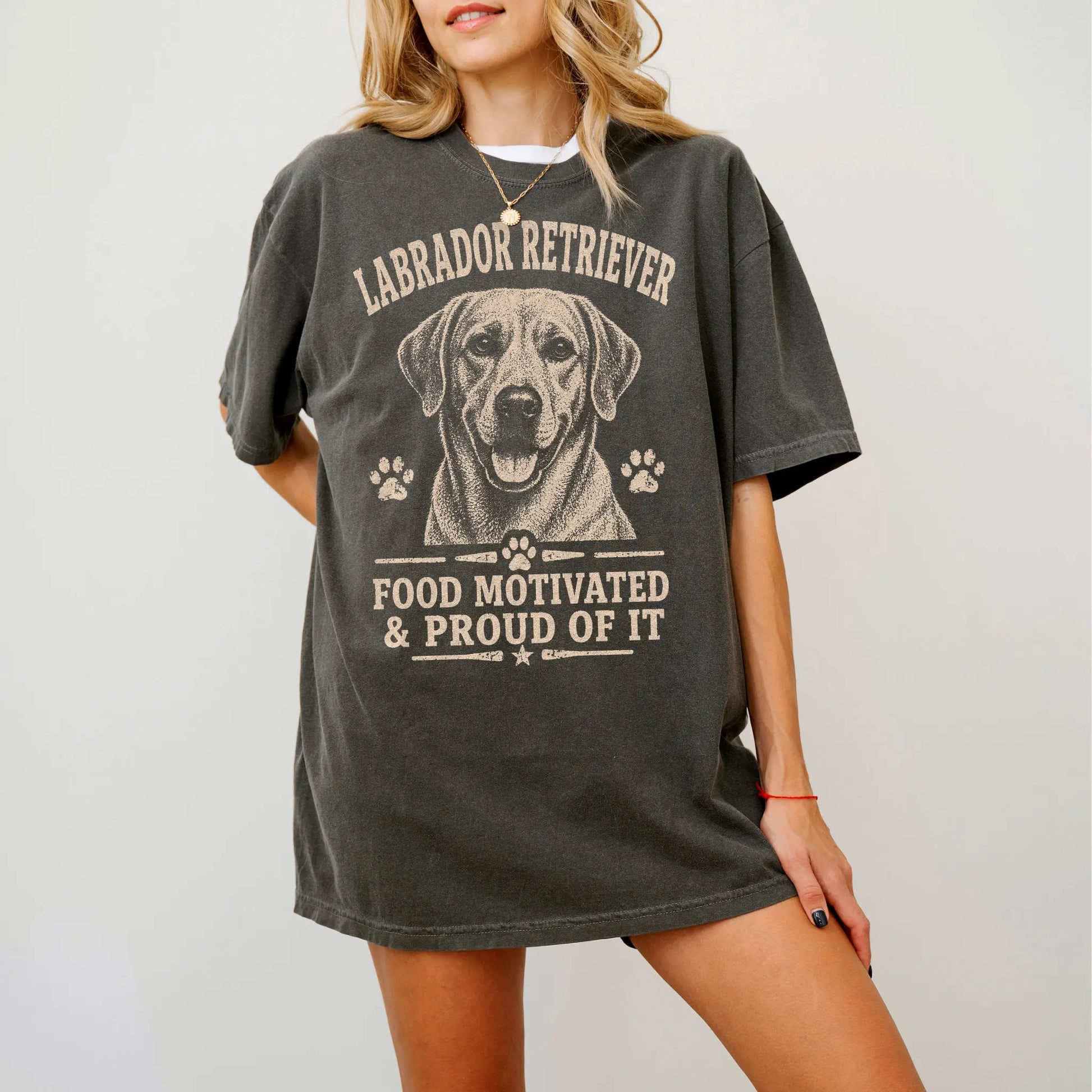Model wearing a Pepper Comfort Colors® T-shirt featuring Labrador Retriever design with “Food Motivated & Proud Of It” letter