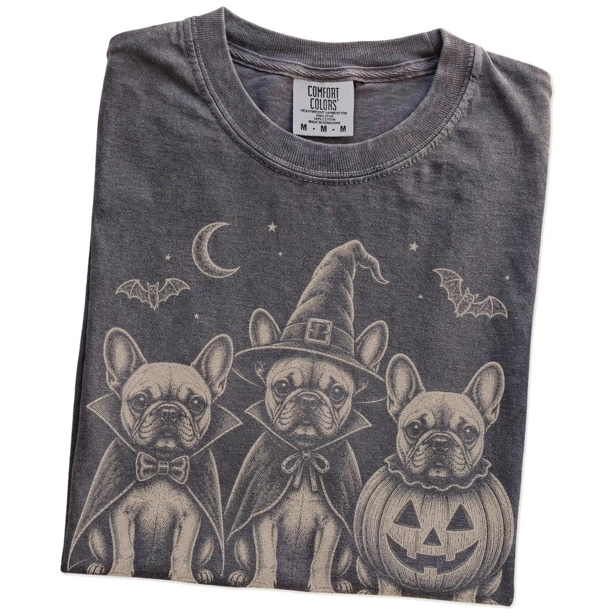 Folded Pepper Comfort Colors® T-shirt showing three French Bulldog dogs dressed for Halloween beneath bats and a crescent moo