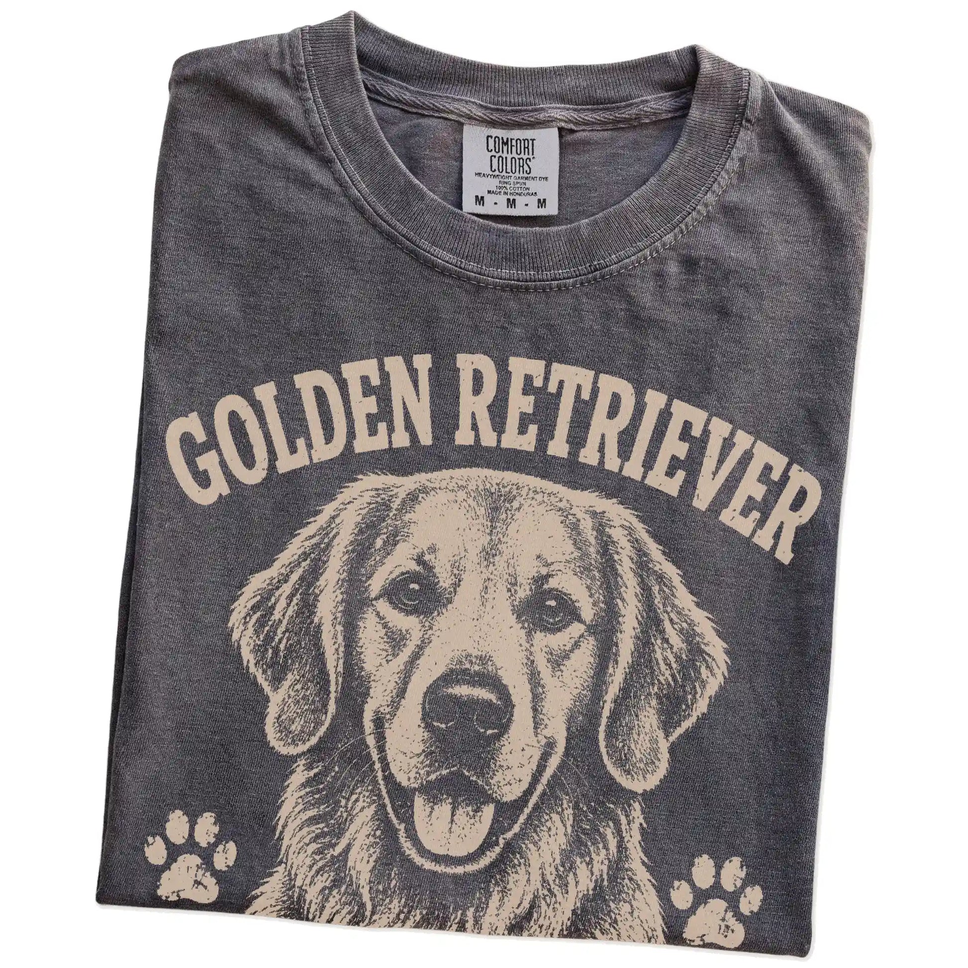 Folded Pepper Comfort Colors® T-shirt showing Golden Retriever design with “Friendly Is My Default Setting” lettering