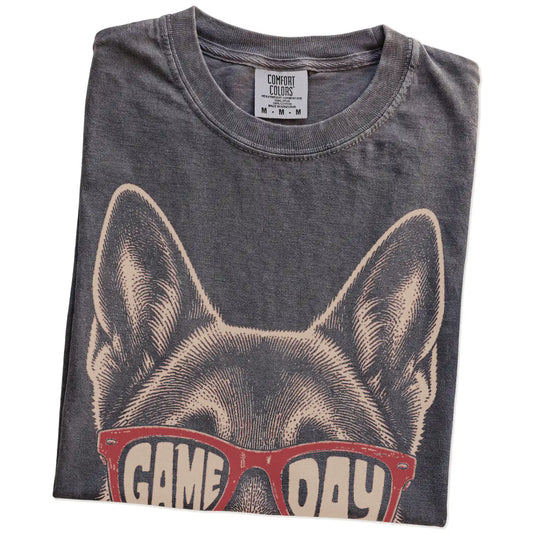 Folded Pepper Comfort Colors® T-shirt showing german shepherd wearing red game day sunglasses
