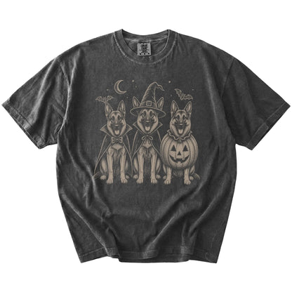 Three German Shepherd dogs dressed for Halloween beneath bats and a crescent moon on a Pepper Comfort Colors® T-shirt