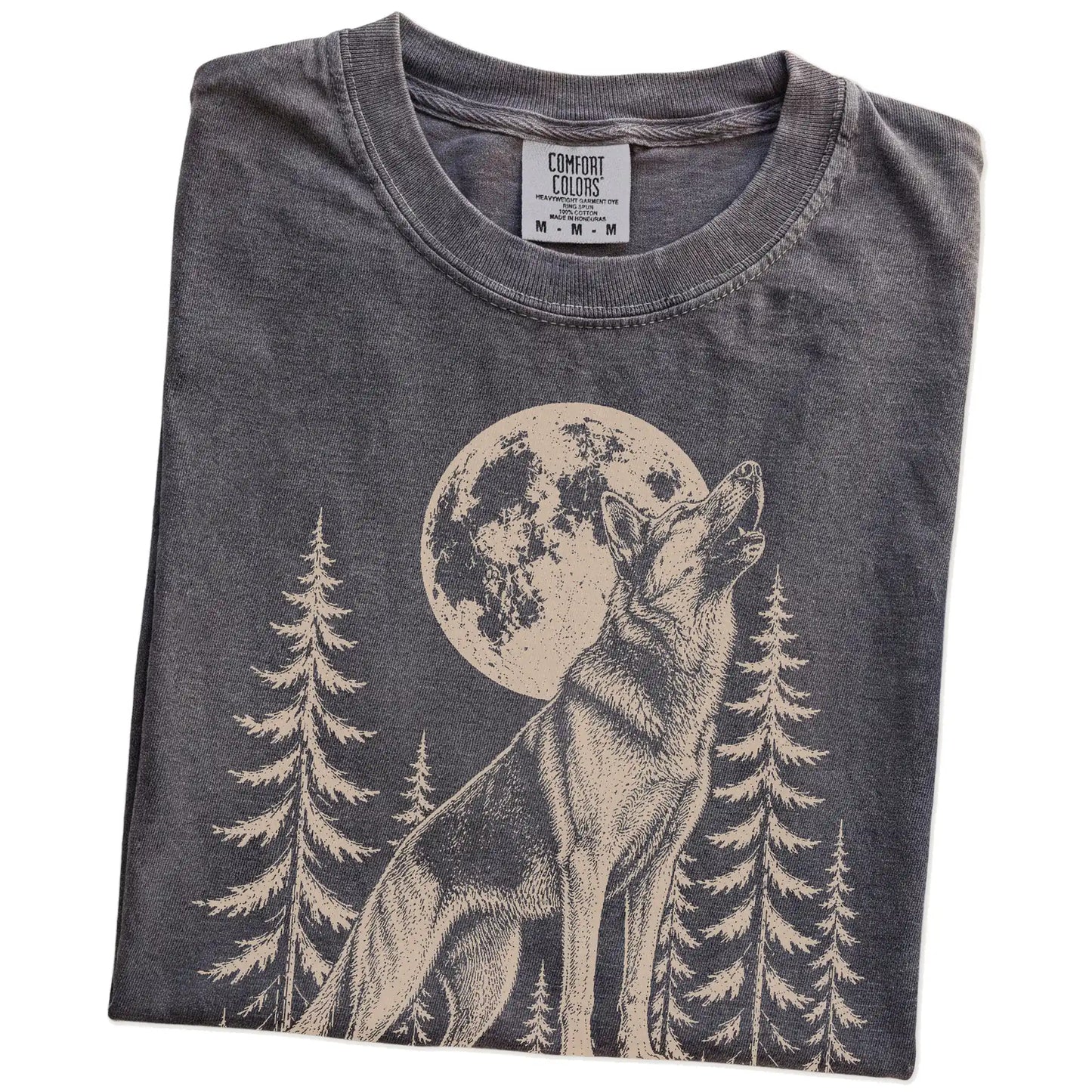 Folded Pepper Comfort Colors® T-shirt showing a German Shepherd howling beneath the moon and pine trees