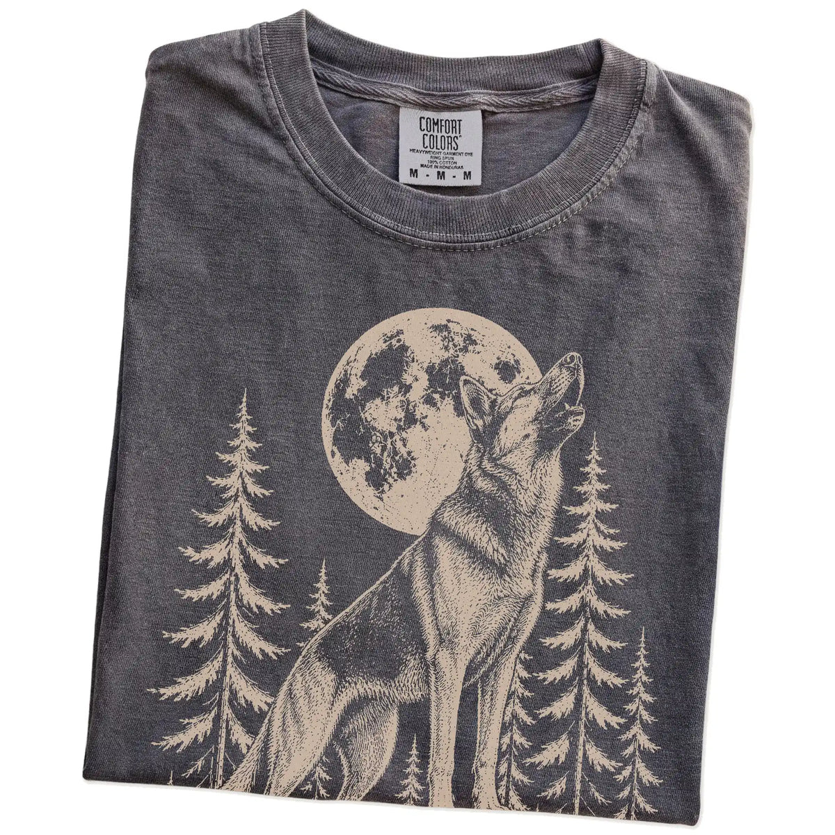 Folded Pepper Comfort Colors® T-shirt showing a German Shepherd howling beneath the moon and pine trees