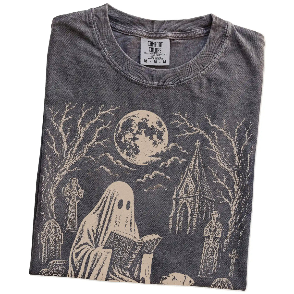 Folded Pepper Comfort Colors® T-shirt showing American Bulldog beside a reading ghost in a moonlit graveyard