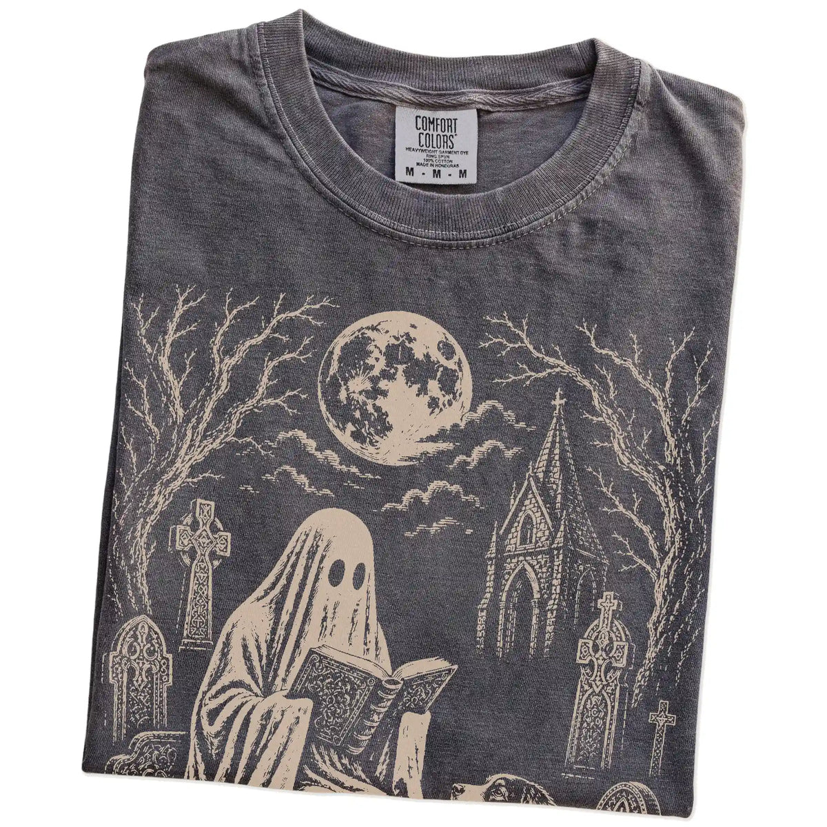 Folded Pepper Comfort Colors® T-shirt showing Australian Shepherd beside a reading ghost in a moonlit graveyard