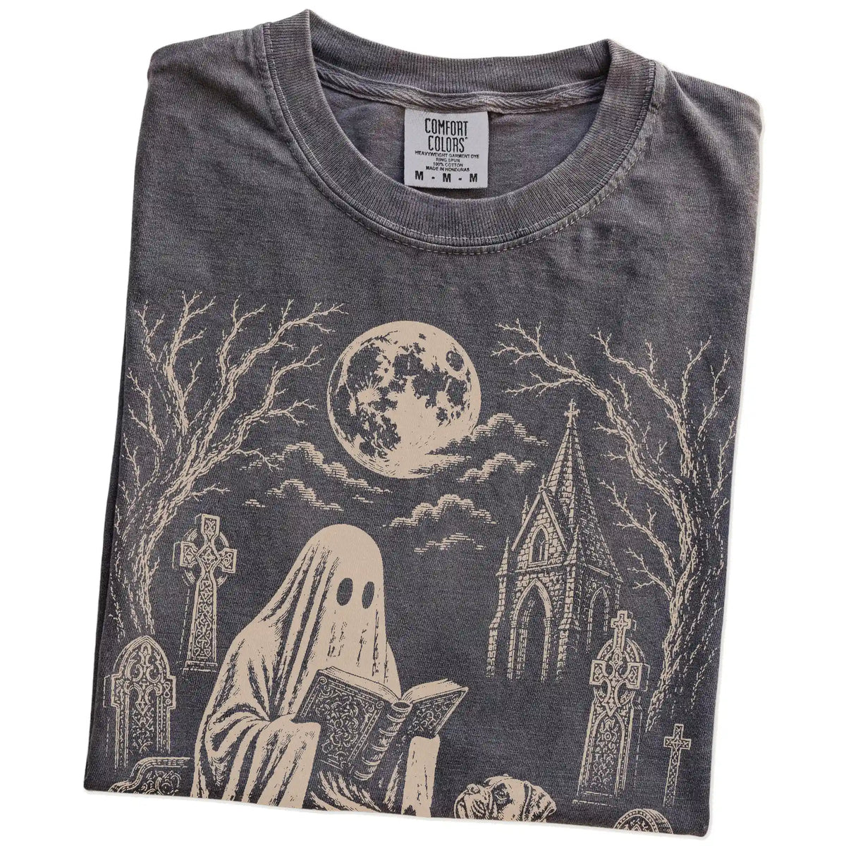 Folded Pepper Comfort Colors® T-shirt showing Boxer beside a reading ghost in a moonlit graveyard