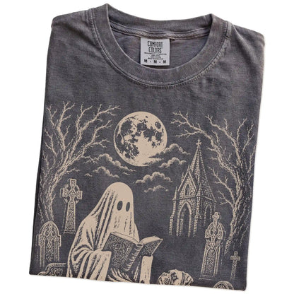 Folded Pepper Comfort Colors® T-shirt showing Boxer beside a reading ghost in a moonlit graveyard